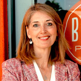 Elise Wetzel standing in front of a Blaze Pizza sign