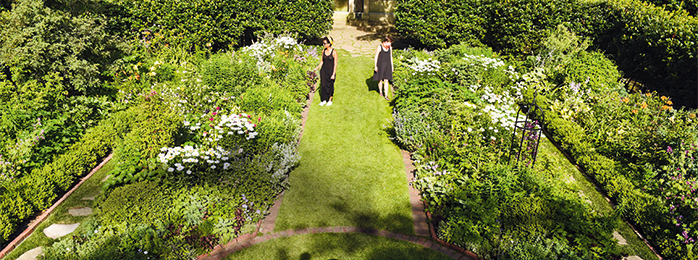 two women standing in the Shakespeare garden