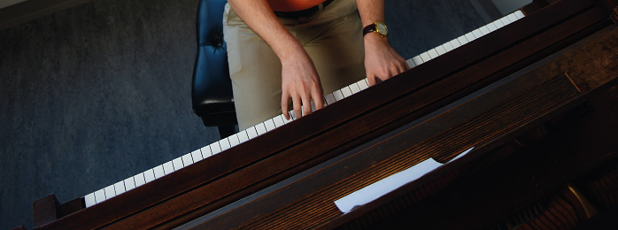 Image of a person playing a piano.