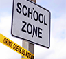 Sign saying School Zone with yellow tape on the bottom